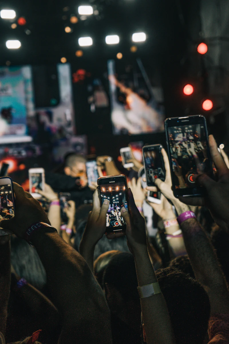 Crowd of fans holding up phones — professional chatting that turns fans into revenue